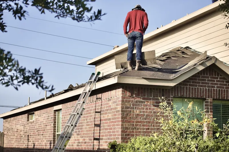 Professional roofer working on a residential roof in Galesville Estates